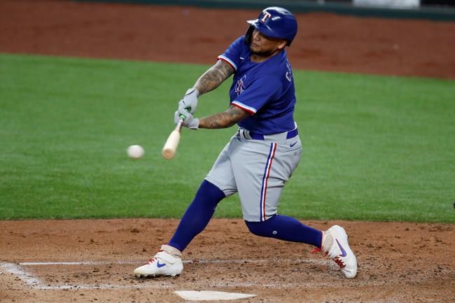 Texas Rangers' Willie Calhoun connects for a hit during an intrasquad practice baseball game at Globe Life Field in Arlington, Texas, Monday, July 6, 2020. (AP Photo/Tony Gutierrez)