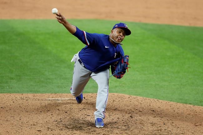 Texas Rangers pitcher Edinson Volquez throws to the plate in an intrasquad game during baseball practice at Globe Life Field in Arlington, Texas, Friday, July 10, 2020. (AP Photo/Tony Gutierrez)