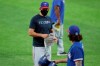 Texas Rangers manager Chris Woodard, left, speaks to catcher Blake Swihart, right, in an intrasquad game during baseball practice at Globe Life Field in Arlington, Texas, Friday, July 10, 2020. (AP Photo/Tony Gutierrez)