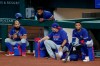 Texas Rangers' Rougned Odor, left, Danny Santana, top, catching coach Hector Ortiz and Willie Calhoun, right, participate in an intrasquad game during baseball practice at Globe Life Field in Arlington, Texas, Friday, July 10, 2020. (AP Photo/Tony Gutierrez)