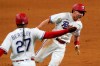 Texas Rangers third base coach Tony Beasley (27) sends Nick Solak home to score on a Brock Holt single during the eighth inning of the team's baseball game against the Toronto Blue Jays in Arlington, Texas, Tuesday, April 6, 2021. (AP Photo/Tony Gutierrez)