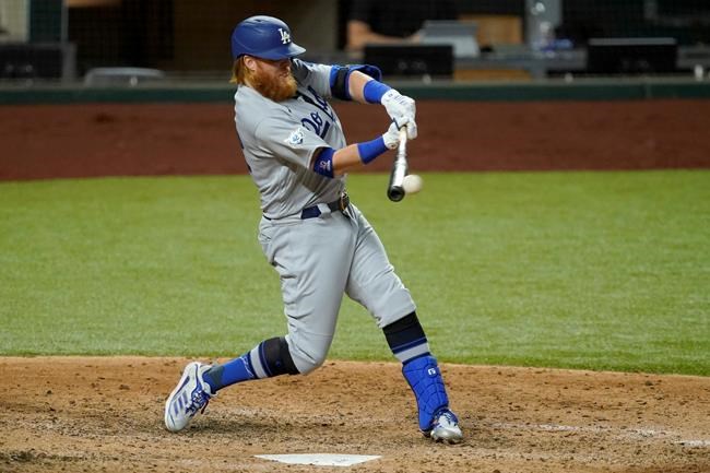 Los Angeles Dodgers' Justin Turner connects for a run-scoring single to left in the seventh inning of a baseball game against the Texas Rangers in Arlington, Texas, Friday, Aug. 28, 2020. The hit scored Corey Seager. (AP Photo/Tony Gutierrez)