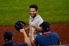 Houston Astros' Jose Altuve celebrates with staff in the dugout after scoring on a Yuli Gurriel single in the eighth inning of a baseball game against the Texas Rangers in Arlington, Texas, Friday, Sept. 25, 2020. (AP Photo/Tony Gutierrez)