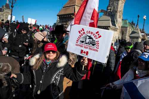 CP
A person holds a sign for the 