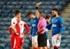 FILE - In this Thursday March 18, 2021 file photo, Slavia Prague's Ondrej Kudela, left, receives a yellow card during the UEFA Europa League Round of Sixteen soccer match at Ibrox Stadium, Glasgow. Slavia Prague defender Ondrej Kudela has appealed his 10-match ban given to him by UEFA for racially abusing a Black opponent in a Europa League soccer match. The law firm that represents him announced the move on Friday April 23, 2021, a day after Kudela received a detailed verdict from UEFA. (Andrew Milligan/PA via AP, file)