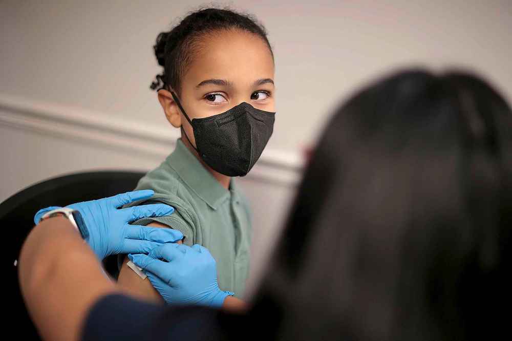 A child receives the Pfizer BioNTech COVID-19 vaccination on Nov. 4, 2021. The federal government approved the coronavirus vaccine for children between the ages of 5 and 11 this week. (Chip Somodevilla/Getty Images/TNS)