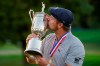 Bryson DeChambeau, of the United States, kisses the winner's trophy after winning US Open Golf Championship, Sunday, Sept. 20, 2020, in Mamaroneck, N.Y. (AP Photo/John Minchillo)