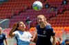 Portland Thorns FC midfielder Rocky Rodriguez, left, and North Carolina Courage midfielder Samantha Mewis, right, battle for the ball during the second half of an NWSL Challenge Cup soccer match at Zions Bank Stadium Saturday, June 27, 2020, in Herriman, Utah. (AP Photo/Rick Bowmer)
