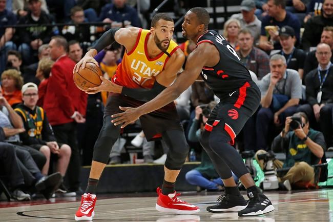 Toronto Raptors center Serge Ibaka (9) guards against Utah Jazz center Rudy Gobert (27) in the first half during an NBA basketball game Monday, March 9, 2020, in Salt Lake City. (AP Photo/Rick Bowmer)