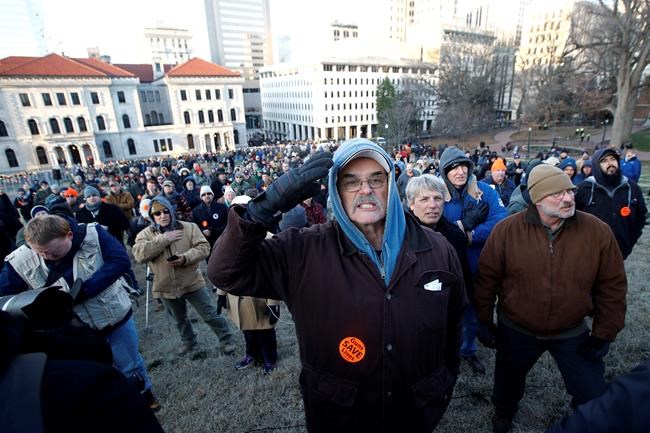 Demonstrators stand on the capitol grounds ahead of a pro gun rally, Monday, Jan. 20, 2020, in Richmond, Va. (AP Photo/Steve Helber)
