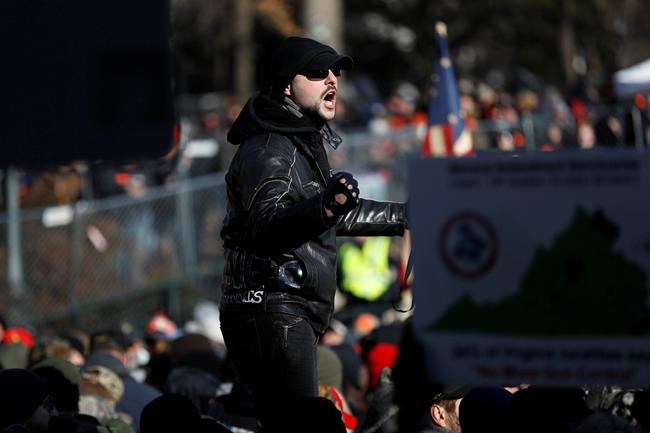 A man speaks during a pro-gun rally, Monday, Jan. 20, 2020, in Richmond, Va. Thousands of pro-gun supporters are expected at the rally to oppose gun control legislation like universal background checks that are being pushed by the newly elected Democratic legislature. (AP Photo/Julio Cortez)