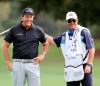 Winner Phil Mickelson gets a pat on the back from Jeff Johnson, the caddie for Retief Goosen, during final round play in the Dominion Energy Charity Classic at the Country Club of Virginia in Richmond, Virginia, on Sunday, October 18, 2020. Mickelson finished 3 strokes ahead of Canada's Mike Weir. (Joe Mahoney/Richmond Times-Dispatch via AP)