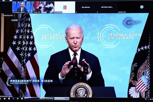 U.S. President Joe Biden is seen on a screen as European Council President Charles Michel attends a virtual Global Climate Summit via video link from the European Council building in Brussels, Thursday, April 22, 2021. (Johanna Geron, Pool via AP)