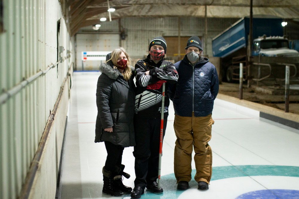 When COVID-19 public health orders forced curling clubs to close in early November, Faith (from left), Aaron and Jeff van Ryssel built their own rink. (Rosanna Hempel / Winnipeg Free Press)