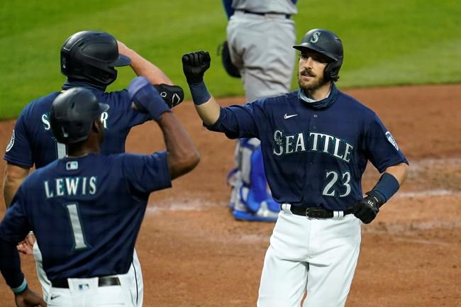 Seattle Mariners' Austin Nola (23) is greeted at home on his three-run home run by Kyle Lewis (1) and Kyle Seager during the third inning of a baseball game against the Los Angeles Dodgers on Wednesday, Aug. 19, 2020, in Seattle. (AP Photo/Elaine Thompson)