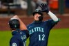 Seattle Mariners' Evan White (12) is congratulated by Kyle Seager after hitting a three-run home run against the Houston Astros in the seventh inning of a baseball game Monday, Sept. 21, 2020, in Seattle. (AP Photo/Elaine Thompson)