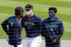 From left to right, Seattle Mariners Kyle Lewis, Kyle Seager and Dee Gordon stand together at a 