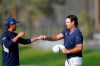 Patrick Reed, right, greets Rickie Fowler after the two finished on the ninth hole of the North Course during the first round of the Farmers Insurance golf tournament at Torrey Pines on Thursday, Jan. 28, 2021, in San Diego. (AP Photo/Gregory Bull)