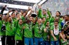 FILE - In this Nov. 10, 2019, file photo, Seattle Sounders players celebrate after beating the Toronto FC in the MLS Cup championship soccer match in Seattle. The Sounders victory was among Washington state's top news stories of 2019. (AP Photo/Elaine Thompson, File)
