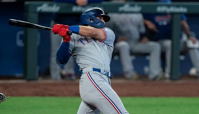 Texas Rangers' Joey Gallo hits a two-run double off of Seattle Mariners starting pitcher Marco Gonzales that scored Rangers' Shin-Soo Choo and Isiah Kiner-Falefa during the fourth inning of a baseball game, Monday, Sept. 7, 2020, in Seattle. (AP Photo/Stephen Brashear)