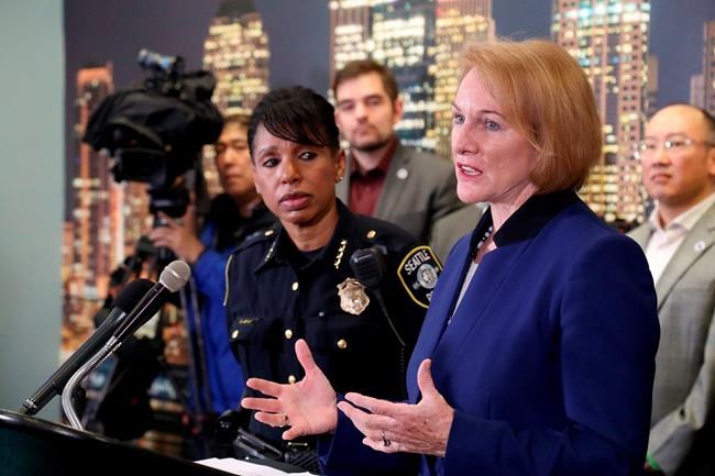 At a press conference at the West Precinct of the Seattle Police Department, Thursday, January 23,2020, Mayor Jenny Durkan, right, discusses issues regarding downtown safety on 3rd Avenue where a 5:01 pm shooting Wednesday, Jan. 22 shooting occurred. Looking on at left is Seattle Police Chief Carmen Best. (Greg Gilbert/The Seattle Times via AP)