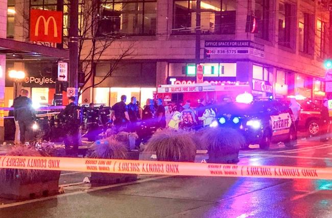 Police work the scene of a shooting on Third Avenue and Pine Street, Wednesday, Jan. 22, 2020, in Seattle. (Amanda Snyder/The Seattle Times via AP)