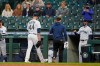Fans watch as Seattle Mariners starting pitcher James Paxton (44) heads to the clubhouse with a trainer during the second inning of the team's baseball game against the Chicago White Sox, Tuesday, April 6, 2021, in Seattle. Paxton was replaced by Nick Margevicius. (AP Photo/Ted S. Warren)