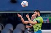 Seattle Sounders midfielder Alex Roldan, right, and Minnesota United defender Chase Gasper, left, vie for a header during the first half of an MLS soccer match Friday, April 16, 2021, in Seattle. (AP Photo/Ted S. Warren)