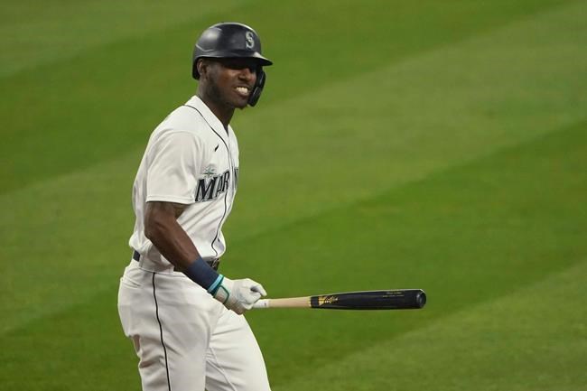 Seattle Mariners' Kyle Lewis pumps his fist after he was walked with the bases loaded in the sixth inning of the first seven-inning baseball game of a doubleheader against the Oakland Athletics, Monday, Sept. 14, 2020, in Seattle. (AP Photo/Ted S. Warren)