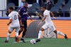 Los Angeles Galaxy forward Samuel Grandsir (11) looks to pass as Seattle Sounders defender Nouhou, center, looks on during the first half of an MLS soccer match, Sunday, May 2, 2021, in Seattle. (AP Photo/Ted S. Warren)