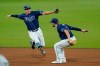 Tampa Bay Rays outfielders Willy Adames, left, and Brandon Lowe, right, prepare to leap in celebration after the Rays beat the New York Yankees 7-5 in Game 2 of a baseball American League Division Series Tuesday, Oct. 6, 2020, in San Diego. (AP Photo/Gregory Bull)