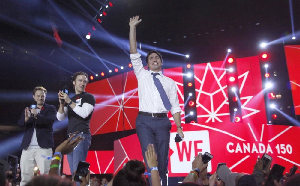 Prime Minister Justin Trudeau (right) along with WE co-founders, Craig (middle) and Marc Kielburger at WE Day in Ottawa in 2016. (MarketWired / We Day files)