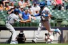 Los Angeles Dodgers' AJ Pollock is congratulated by third base coach Dino Ebel after hitting a home run during the first inning of a baseball game against the Milwaukee Brewers Sunday, May 2, 2021, in Milwaukee. (AP Photo/Aaron Gash)