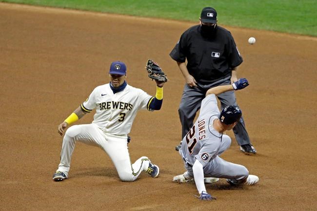 Milwaukee Brewers' Orlando Arcia (3) is unable to control a throw as Detroit Tigers' JaCoby Jones (21) steals second base during the fourth inning of a baseball game Tuesday, Sept. 1, 2020, in Milwaukee. Jones advanced to third base on the play. (AP Photo/Aaron Gash)
