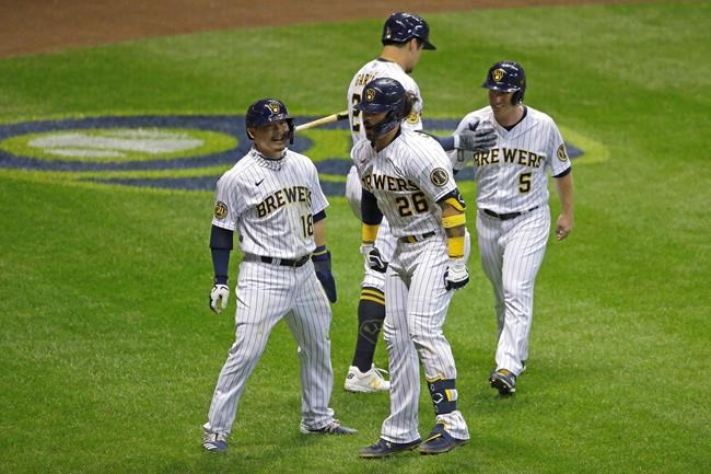 Milwaukee Brewers' Jacob Nottingham (26) celebrates with teammates after hitting a grand slam during the fourth inning of the Brewers' baseball game against the Kansas City Royals on Friday, Sept. 18, 2020, in Milwaukee. (AP Photo/Aaron Gash)