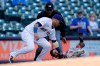 Minnesota Twins' Andrelton Simmons (9) slides in safely at third base past the tag of Milwaukee Brewers' Orlando Arcia during the eighth inning of a baseball game Sunday, April 4, 2021, in Milwaukee. (AP Photo/Aaron Gash)