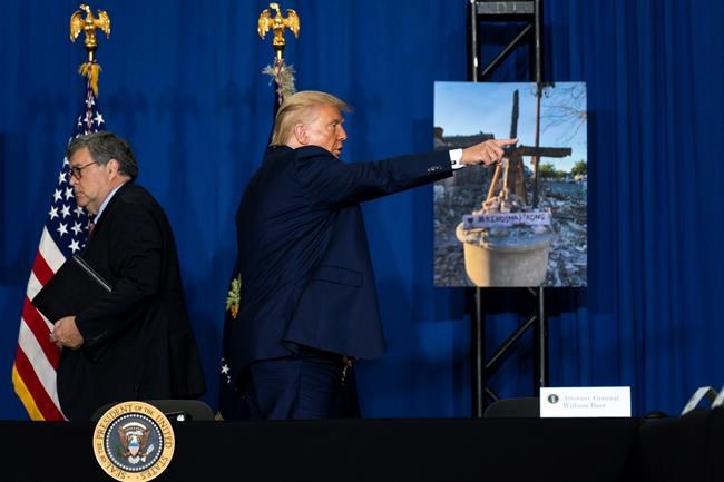 President Donald Trump gestures as a roundtable ends at Mary D. Bradford High School, Tuesday, Sept. 1, 2020, in Kenosha, Wis, as Attorney General William Barr walks. (AP Photo/Evan Vucci)
