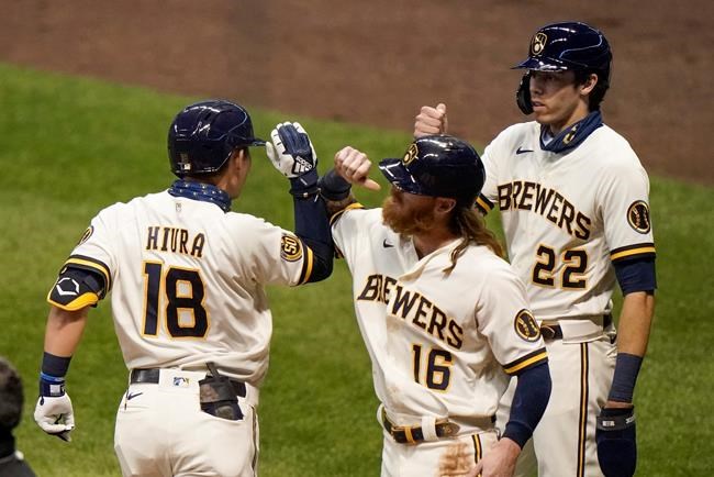 Milwaukee Brewers' Keston Hiura is congratulated by Ben Gamel (16) and Christian Yelich (22) after hitting a three-run home run during the third inning of a baseball game against the Detroit Tigers Wednesday, Sept. 2, 2020, in Milwaukee. (AP Photo/Morry Gash)