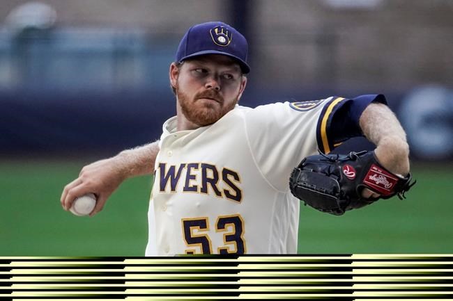 Milwaukee Brewers' Brandon Woodruff throws during a practice session Saturday, July 4, 2020, at Miller Park in Milwaukee. (AP Photo/Morry Gash)