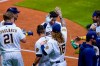 Milwaukee Brewers' Ryan Braun is congratulated after hitting a game-winning sacrifice fly during the ninth inning of a baseball game against the Chicago Cubs Friday, Sept. 11, 2020, in Milwaukee. The Brewers won 1-0. (AP Photo/Morry Gash)