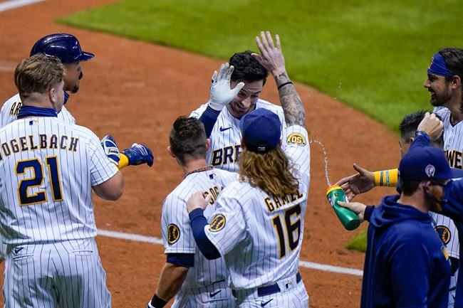 Milwaukee Brewers' Ryan Braun is congratulated after hitting a game-winning sacrifice fly during the ninth inning of a baseball game against the Chicago Cubs Friday, Sept. 11, 2020, in Milwaukee. The Brewers won 1-0. (AP Photo/Morry Gash)