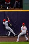 Cincinnati Reds' Phillip Ervin can't catch a home run hit by Milwaukee Brewers' Logan Morrison during the fourth inning of a baseball game Friday, Aug. 7, 2020, in Milwaukee. (AP Photo/Morry Gash)