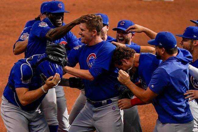 Chicago Cubs starting pitcher Alec Mills is swarmed by teammates after throwing a no hitter at a baseball game against the Milwaukee Brewers Sunday, Sept. 13, 2020, in Milwaukee. The Cubs won 12-0. (AP Photo/Morry Gash)