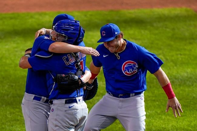 Chicago Cubs starting pitcher Alec Mills is congratulated by teammates catcher Victor Caratini and Anthony Rizzo after throwing a no hitter at a baseball game against the Milwaukee Brewers Sunday, Sept. 13, 2020, in Milwaukee. The Cubs won 12-0. (AP Photo/Morry Gash)