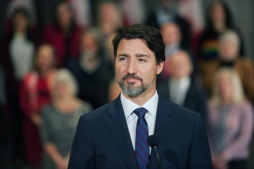 Prime Minister Justin Trudeau stands in front of his cabinet as he speaks to media during the final day of the Liberal cabinet retreat at the Fairmont Hotel in Winnipeg, Tuesday, Jan. 21, 2020. THE CANADIAN PRESS/Mike Sudoma