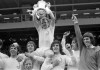 FILE - In this file photo dated May 6, 1972, Leeds United captain Billy Bremner, seated on the shoulders of his teammates, shows the FA Cup to the Leeds fans after their 1-0 victory over Arsenal at Wembley, London, with from left to right, Johnny Giles, Jack Charlton, Allan Clarke who scored the winning goal, Peter Lorimer, Norman Hunter and goalkeeper David Harvey. Norman Hunter, a former Leeds defender who was part of England's World Cup-winning squad in 1966, died Friday April 17, 2020 with COVID-19 coronavirus, aged 76. (AP Photo/Bob Dear, FILE)