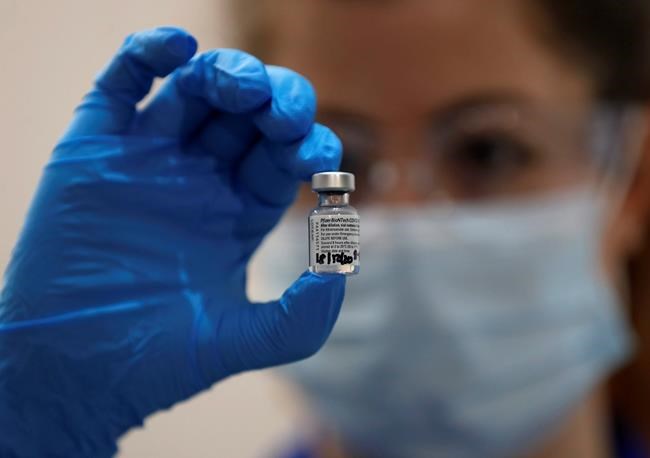 A nurse holds a phial of the Pfizer-BioNTech COVID-19 vaccine at Guy's Hospital in London, Tuesday, Dec. 8, 2020, as the U.K. health authorities rolled out a national mass vaccination program. U.K. regulators said Wednesday Dec. 9, 2020, that people who have a “significant history’’ of allergic reactions shouldn’t receive the new Pfizer/BioNTech vaccine while they investigate two adverse reactions that occurred on the first day of the country’s mass vaccination program. (AP Photo/Frank Augstein, Pool)