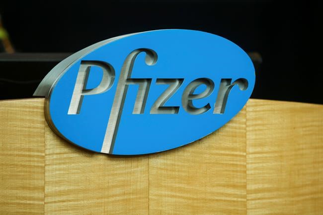 FILE - In this file photo dated Wednesday, July 22, 2020, a Pfizer sign is seen on a podium at the Pfizer Research & Development Laboratories, in Groton, USA. The U.K. health authorities rolled out a national mass vaccination program Tuesday Dec. 8, 2020, using the Pfizer-BioNTech COVID-19 vaccine. U.K. regulators said Wednesday Dec. 9, 2020, that people who have a “significant history’’ of allergic reactions shouldn’t receive the new Pfizer/BioNTech vaccine while they investigate two adverse reactions that occurred on the first day of the country’s mass vaccination program. (AP Photo/Stew Milne)
