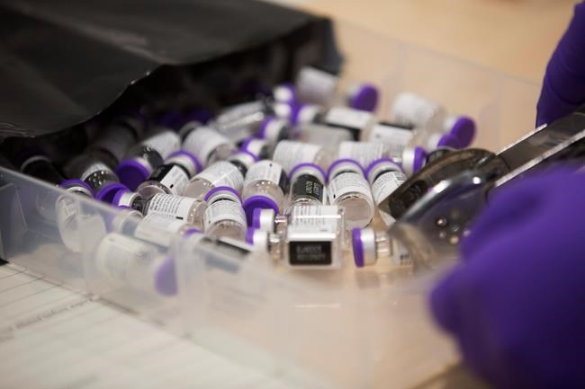 The Pfizer-BioNTech COVID-19 vaccine bottles, as the mass public vaccination program gets underway at Southmead Hospital in Bristol, England, Tuesday Dec. 8, 2020. The United Kingdom, one of the countries hardest hit by the coronavirus, is beginning its vaccination campaign to inoculate people against the COVID-19 virus. (Graeme Robertson/Pool via AP)