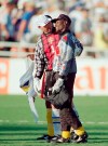 FILE - In this file photo dated Sunday, June 19, 1994, Goalkeeper Thomas Ravelli of Sweden, left, and Joseph-Antoine Bell of Cameroon hug each other as they walk out of the field after the 2-2 tie of the Sweden Vs Cameroon Group B first round match of the World Cup soccer championship at the Rose Bowl in Pasadena, USA. The extrovert Sweden goalkeeper Ravelli who helped give the Scandinavian nation one of its greatest sporting rushes when the Sweden team reached the semifinals of the 1994 World Cup in the United States, and Sweden's national TV broadcaster plans to replay the team's games over the coming weeks in an attempt to unite the nation during the coronavirus pandemic. (AP Photo/Lois Bernstein, File)